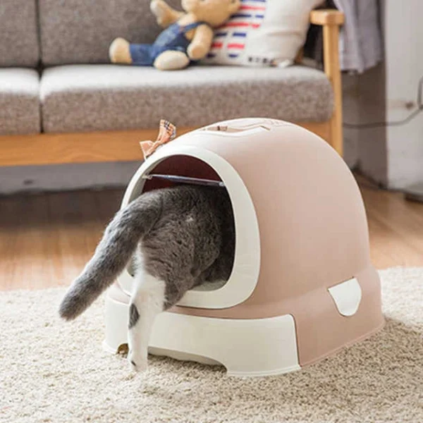 Cat entering the circular enclosed cat litter box, with the design minimizing litter scatter