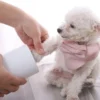 Demonstrating the Paw Cleaner Cup in use, with a dog's paw being gently cleaned by the silicone bristles